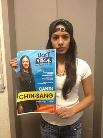 Candi Chin-Sang holding one of posters she says misrepresented her platform. SARAH NIEDOBA/THE VARSITY
