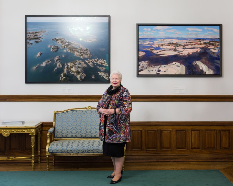 Dowdeswell posing with artwork from an exhibition on the Great Lakes. BENJAMIN LAPPALAINEN/THE VARSITY