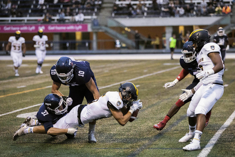 Varsity Blues football team snap long losing streak in home opener ...