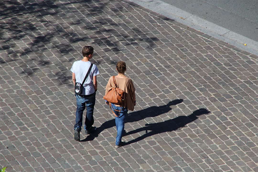 Two people walking together on the street.