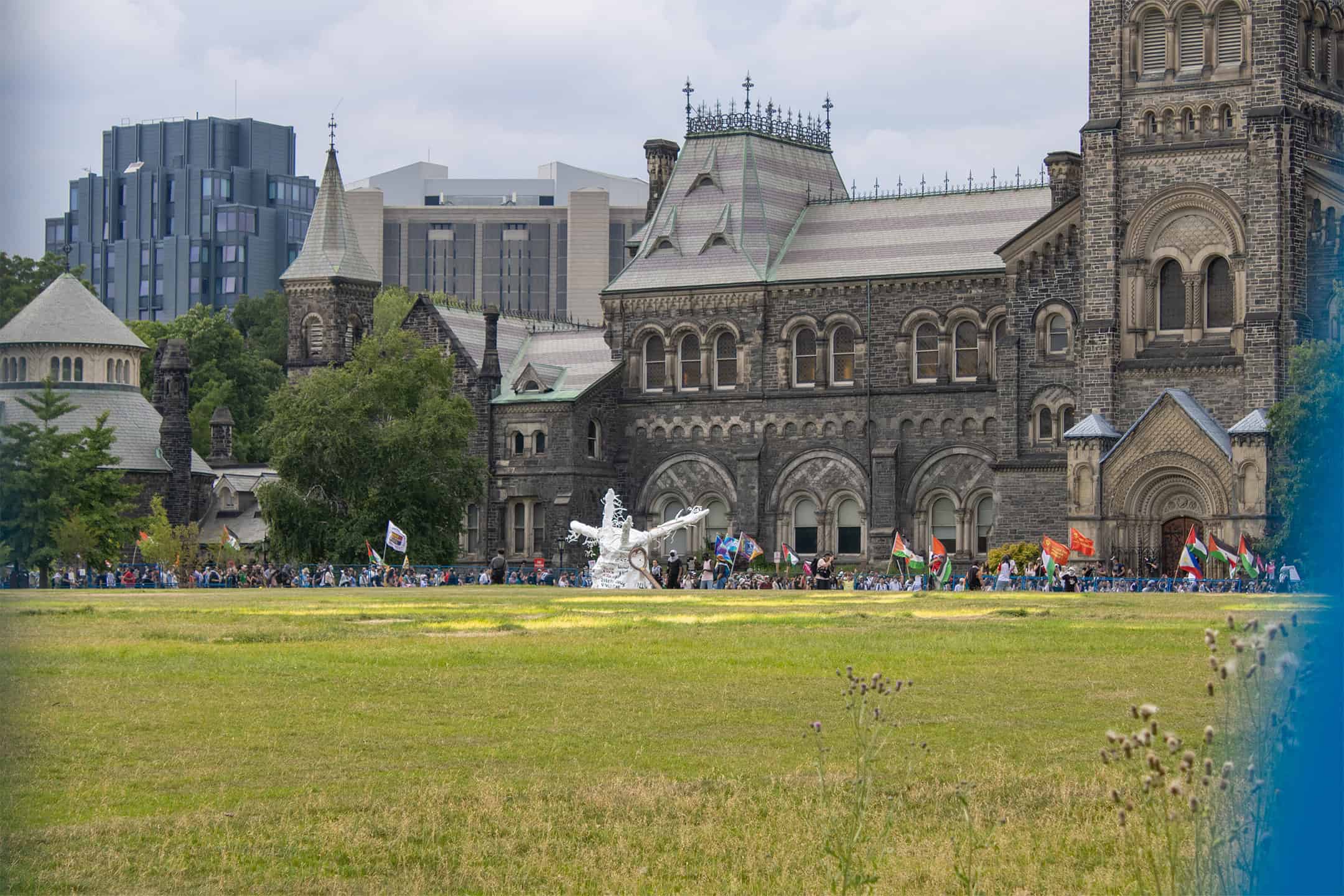 Protesters gather outside empty field. JAMES BULLANOFF/THEVARSITY